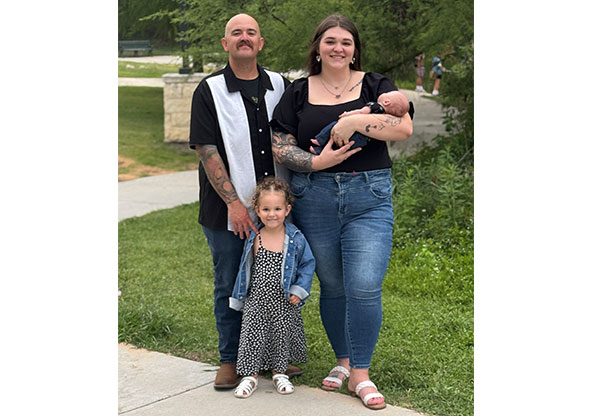 Cierra and her family smile for a portrait
