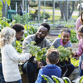 Man and kids in a community garden