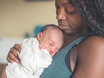 mom cuddling with new born
